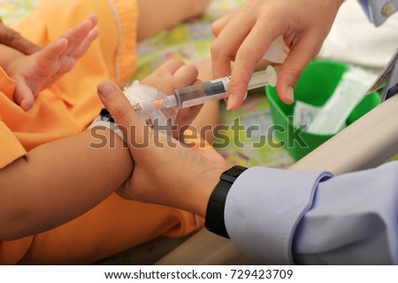 Nurse giving an injection Disinfect to a child patient