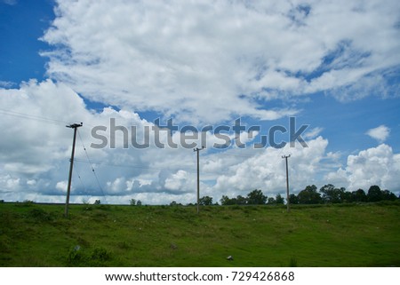 Lamp post on earthen dyke of sky background