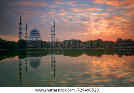 Reflection of beautiful Shah Alam mosque during sunrise