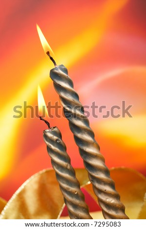 Two christmas candles over color background, vertical composition. Shallow DOF