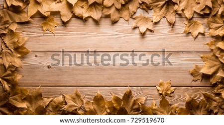 background frame of autumn leaves on wooden boards
