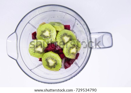 Some healthy kiwi's and dragon glass and some melons in a blender makes a very healthy juice for the start of your day .