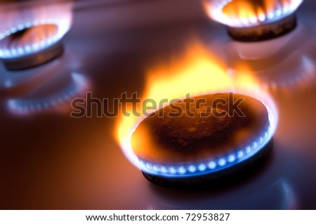 Gas burner with yellow flame in the kitchen oven Royalty-Free Stock Photo #72953827