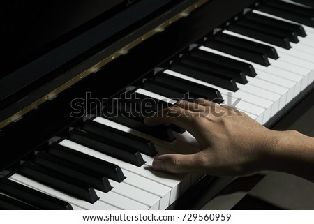 Man playing piano in the studio with close up shot,Blurred moving hand