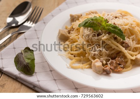 Pasta Carbonara. Spaghetti with bacon, basil and parmesan cheese. Pasta Carbonara on white plate on white dish. Italian food concept. close-up picture for a recipe. selective focus