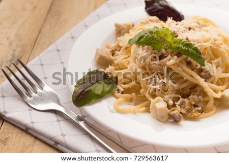 Pasta Carbonara. Spaghetti with bacon, basil and parmesan cheese. Pasta Carbonara onwhite  linen plate on white dish. Italian food concept. close-up picture for a recipe. selective focus
