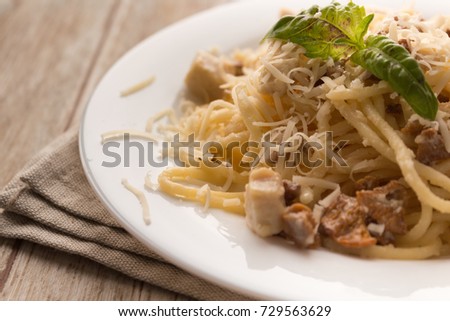 Pasta Carbonara. Spaghetti with bacon and parmesan cheese. Pasta Carbonara on linen plate on wooden background. Italian food concept. close-up picture for a recipe. selective focus
