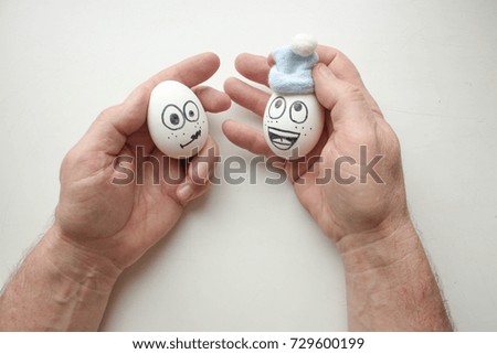 health and flu winter concept. funny eggs smiling in hat and hands. horizontal sheet orientation