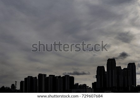 Rain clouds and silhouette city. / Gray sky and silhouette city. / Abstract Background.