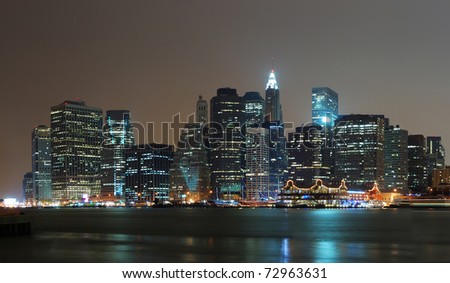 New York City Manhattan night scene panorama with city skyline over Hudson River.