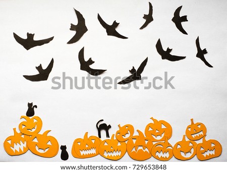 Postcard with halloween pumpkins and silhouettes of cats and bats