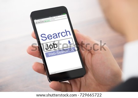 Close-up Of A Hand Holding Mobile Phone Showing Job Search Engine On Browser