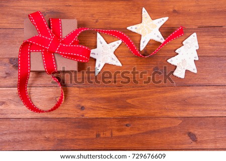 Christmas background: christmas decoration and a gift on a wooden background