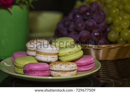 Close up of colorful pasta dessert with vintage pastel tones and a bunch of grapes on a plate.
