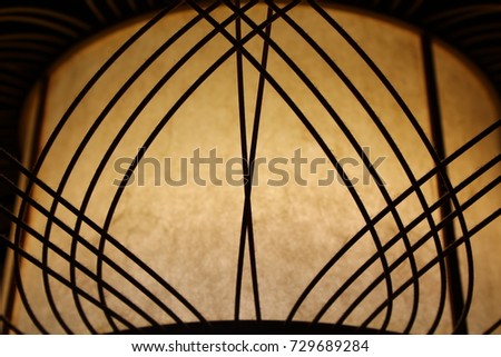 an antique and dusty traditional Japanese home lantern glowing in the dark. 