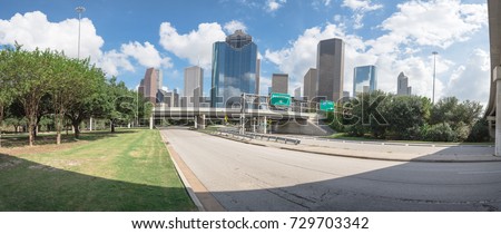 Downtown Houston from Allen Parkway under cloud blue sky