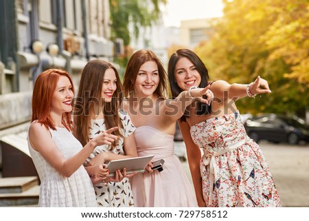 Happy women pointing