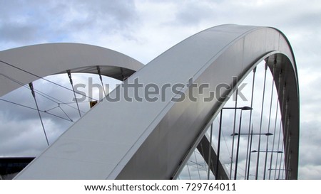 Close-up view on a suspension bridge round steel arch Royalty-Free Stock Photo #729764011