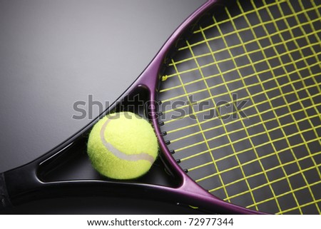 Tennis racquet with ball isolated on the background.