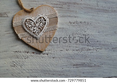 Heart of wood, metal and fabric on wooden gray background  - seasonal and holidays concept 