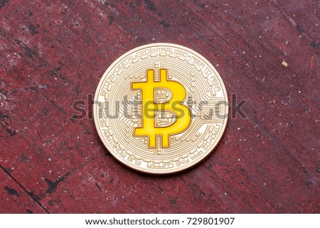 Golden cryptocurrency yellow bitcoin on red background. High resolution photo.