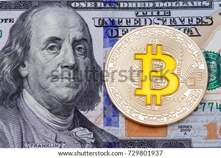 Golden cruptocurrency yellow 'bitcoin on one hundred dollar banknote background. High resolution photo.