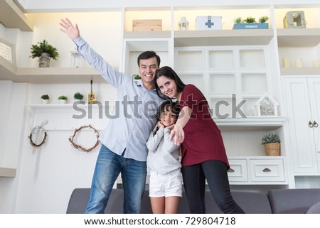 Happy family father, mother and daughter looking camera for take photography at home