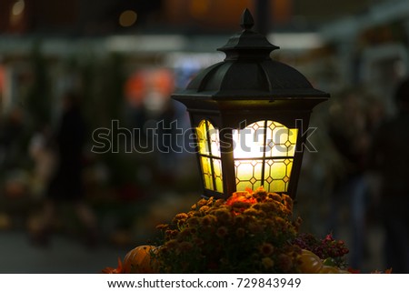 close-up  yellow lantern glows yellow. street lighting. Creating cozy romance  bright lamp with copyspace on  blurred background
