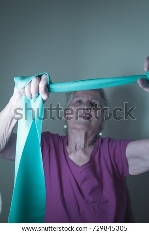 Rehabilitation exercises for older women with elastic band