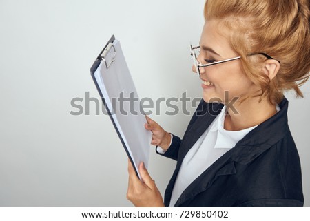 business woman in glasses on a gray background, documents                               