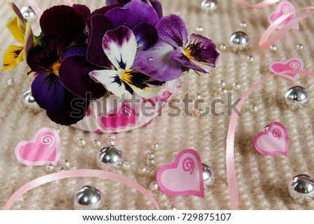 Valentine's Day. Pansies with hearts and ribbons