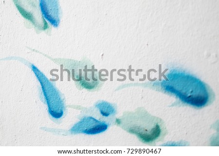 background picture of a white wall with blue and green fish graffiti