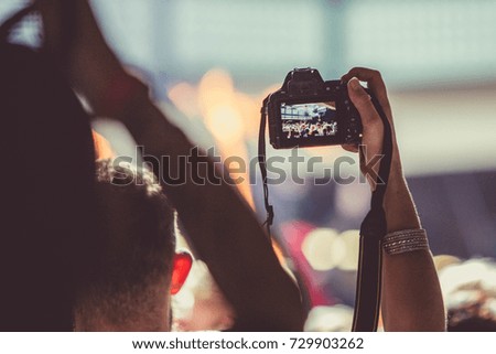 in the crowd taking pictures with camera