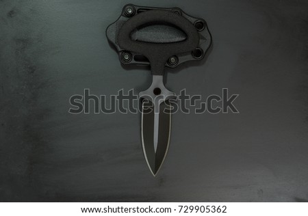 Knife push dagger. Black knife with double edge spear point blade. Black knife and black sheath.