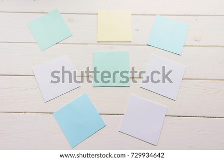 Many square sheets of paper pinned to wooden boards. White-painted surface in a rustic style. Close-up. The top view. Background with copy space