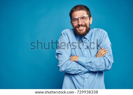  place for copy, work, business man crossed his arms on a blue background                              