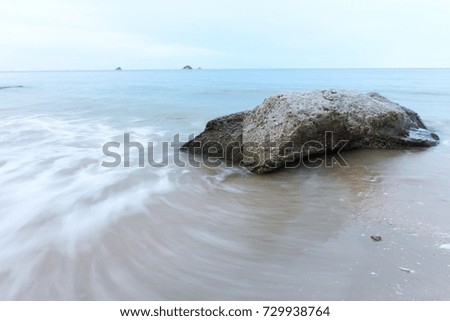 wave bounce the beach in evening time with rock and sand in nature