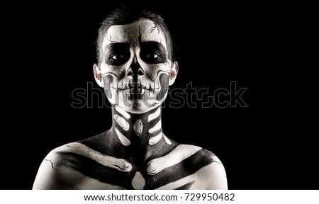 Isolated on black, closeup picture, attractive young brunette caucasian woman with scull body art, grey eyes, languid look