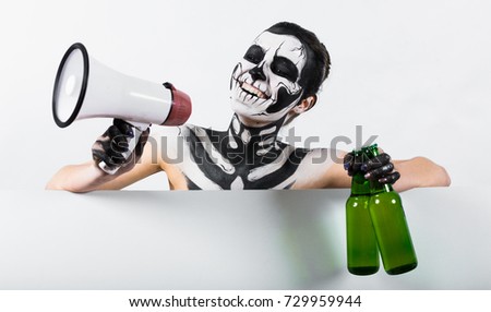 Isolated on white, closeup picture, young brunette caucasian pretty woman with scull body art holds green beer bottles and megaphone, grey eyes, smiling