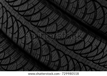 Closeup picture, black rubber automobile tire with protector, turned
