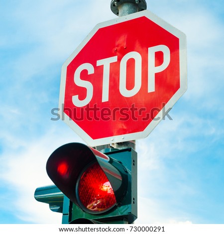 stop sign with red traffic light