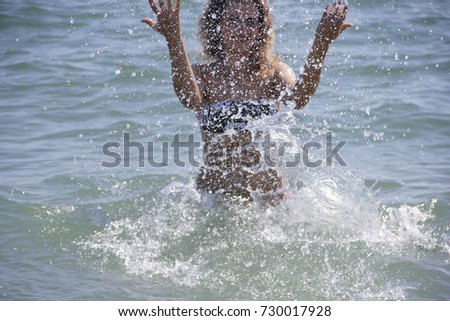 beautiful girl in the sea spray