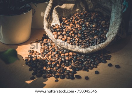 Coffee Beans in a Bag on wooden background.