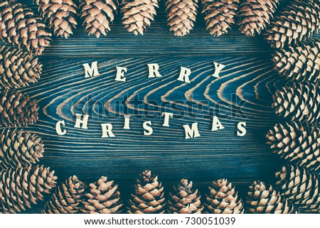 Rustic wooden background with pine cones. Merry Christmas background