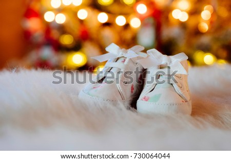 Cute little infants shoes at Christmas tree.