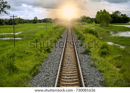 Railroad tracks  in Thailand. When the sun is setting.