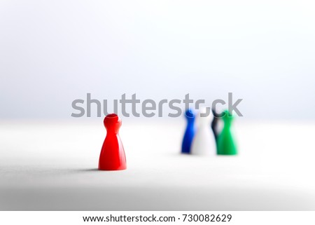 Being alone, outsider and outcast. Racism, discrimination, bullying and social isolation concept. Board game pawns on wooden table. Royalty-Free Stock Photo #730082629