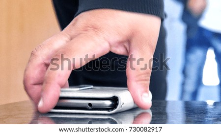hand taking the phone
