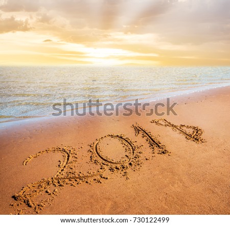 Happy New Year 2018 coming concept. Digits on sand beach