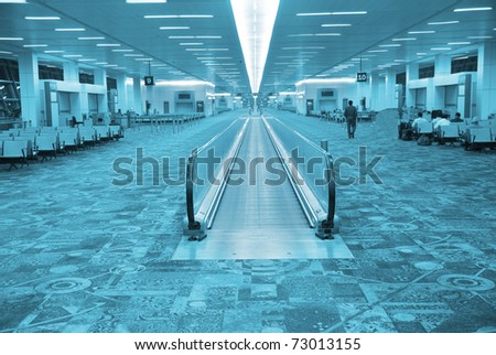 Interior of airport's hall with the flat escalator, Delhi, India